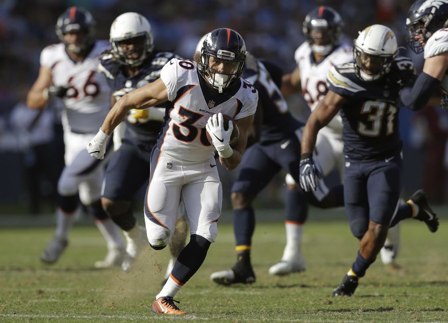 FILE - In this Nov. 18, 2018, file photo, Denver Broncos running back Phillip Lindsay runs for a touchdown during the first half of an NFL football game against the Los Angeles Chargers, in Carson, Calif. More than 330 of college football's finest players are gathering in Indianapolis this week for the NFL's annual combine. Not all of the players who will get drafted in April are on the invite list, however. The biggest snub last year was Colorado running back Phillip Lindsay, the first undrafted offensive player ever selected to the Pro Bowl. (AP Photo/Marcio Jose Sanchez) ** FILE **