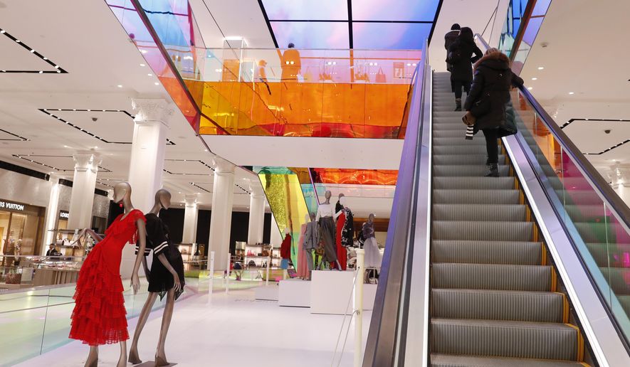 FILE- In this Wednesday, Feb. 20, 2019, file photo shoppers ride the escalator at Saks Fifth Avenue's flagship midtown Manhattan store, in New York. On Tuesday, Feb. 26, the Conference Board releases its February index on U.S. consumer confidence. (AP Photo/Kathy Willens, File)