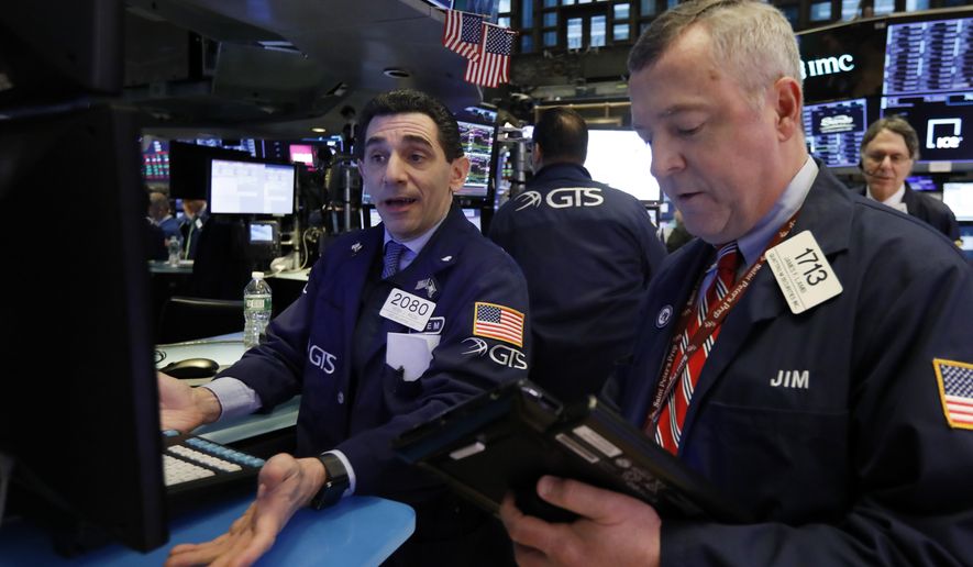 FILE- In this Feb. 8, 2019, file photo specialist Peter Mazza, left, and trader James Lamb work on the floor of the New York Stock Exchange. The U.S. stock market opens at 9:30 a.m. EST on Tuesday, Feb. 26. (AP Photo/Richard Drew, File)