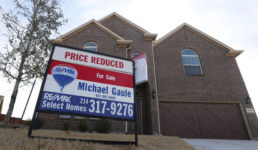 FILE - In this Wednesday, Feb. 20, 2019, photo a price reduced for sale sign sit in front of a home in north Dallas. On Tuesday, Feb. 26, the Standard & Poor's/Case-Shiller 20-city home price index for December is released. (AP Photo/LM Otero, File)