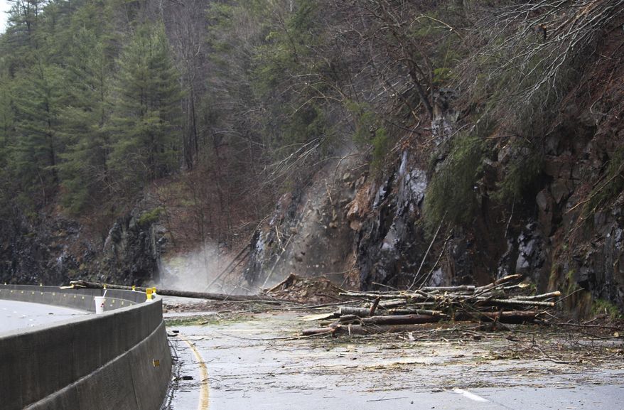 This Saturday, Feb. 23, 2019, photo provided by the North Carolina Department of Transportation (NCDOT) shows debris falling after a landslide covered the westbound lanes of Interstate 40 in Haywood County, N.C., near the Tennessee State line. Landslides have closed portions of highways in western North Carolina. (David Uchiyama/NCDOT via AP)