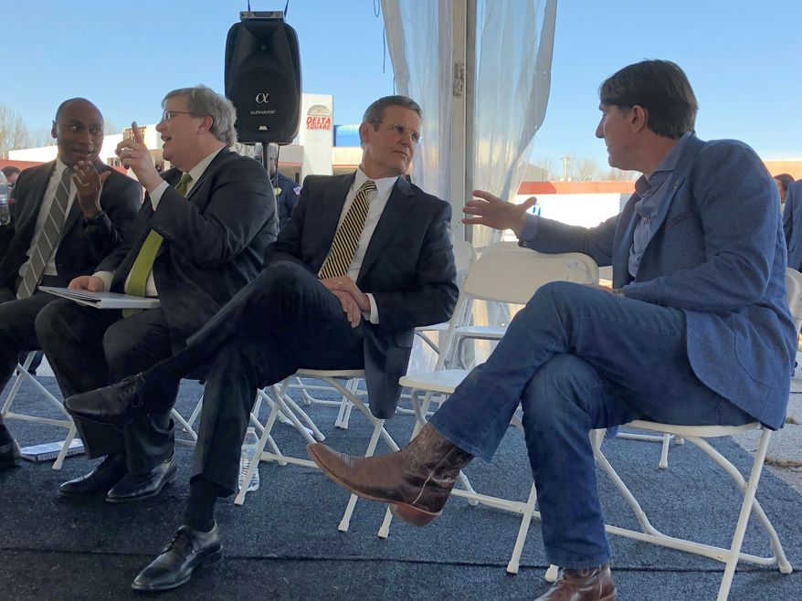 Tennessee Gov. Bill Lee, third from left, speaks with JNJ Express CEO John Ennis Jr., right, during a news conference announcing the trucking company's new headquarters on Tuesday, Feb. 26, 2019 in Memphis, Tenn. Also pictured are Shelby County Mayor Lee Harris, left, at end and Memphis Mayor Jim Strickland, second from left. (AP Photo/Adrian Sainz)