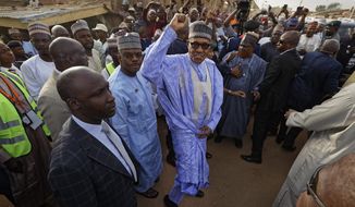 FILE - In this Saturday, Feb. 23, 2019 file photo, Nigeria&#39;s President Muhammadu Buhari gestures to supporters after casting his vote in his hometown of Daura, in northern Nigeria. Nigeria&#39;s president was poised to win a second term in Africa&#39;s largest democracy, with unofficial results on Tuesday, Feb. 26, 2019 showing a victory, his campaign spokesman said. (AP Photo/Ben Curtis, File)
