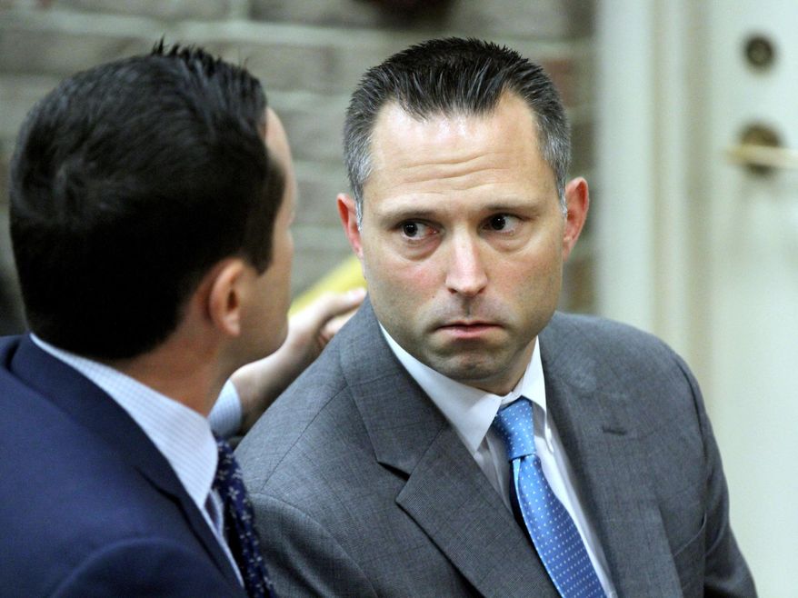 FILE - In this June 12, 2018 file photo, Thomas Tramaglini, right, the Kenilworth Schools superintendent accused of defecating on the track at Holmdel High School, makes his initial appearance in Holmdel Municipal Court in Holmdel, N.J. Tramaglini has asked New Jersey's attorney general to investigate whether police acted unlawfully when they took his mug shot and released it to the media. In a letter to Attorney General Gurbir Grewal on Monday, Feb. 25, 2019, attorney Matthew Adams said the actions by the Holmdel Police Department were designed to "create a media spectacle" around the charges against Tramaglini. (Thomas P. Costello/The Asbury Park Press via AP, Pool)