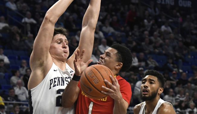 Maryland guard Anthony Cowan Jr. (1) drives to the basket past Penn State forward John Harrar (21), left, and Penn State guard Josh Reaves (23) during the second half of an NCAA college basketball game Wednesday, Feb. 27, 2019, in State College, Pa. Penn State won 78-61. (AP Photo/John Beale)