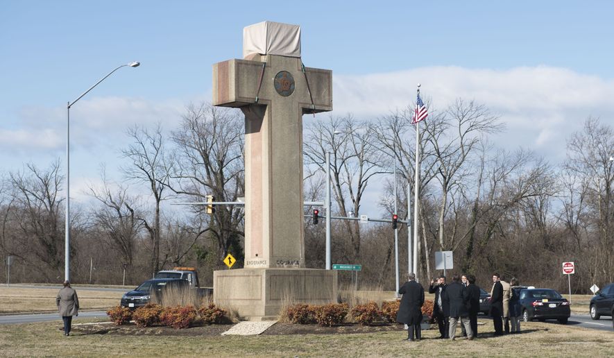 Visitors walk around the 40-foot Maryland Peace Cross dedicated to World War I soldiers on Wednesday, Feb. 13, 2019, in Bladensburg, Md. (AP Photo/Kevin Wolf) ** FILE **