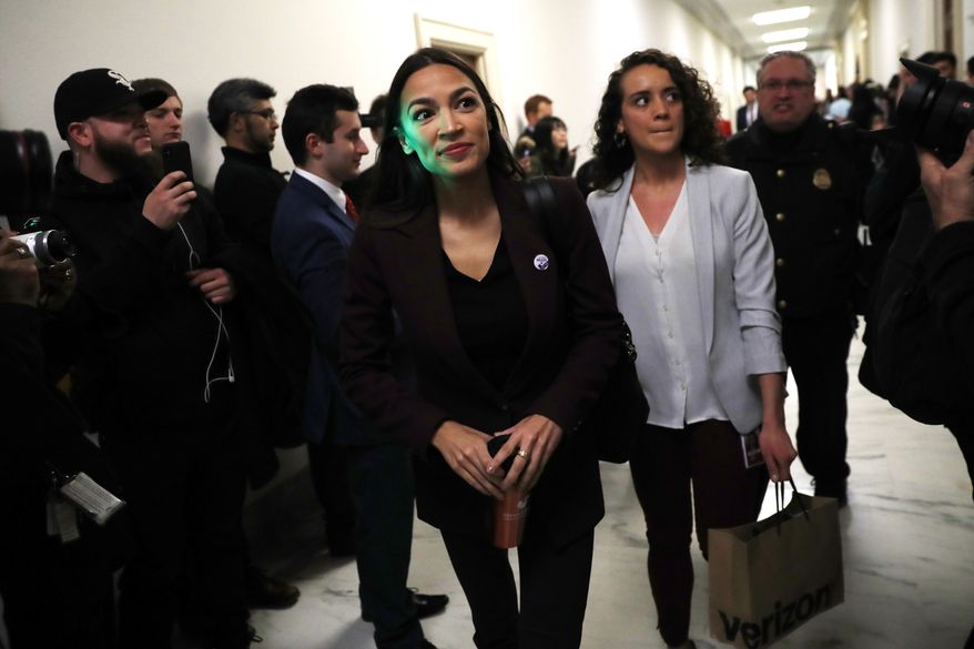 Rep. Alexandria Ocasio-Cortez, D-N.Y., arrives to a hearing where Michael Cohen, President Donald Trump's former personal lawyer, will testify before the House Oversight and Reform Committee on Capitol Hill in Washington, Wednesday, Feb. 27, 2019. Ocasio-Cortez sits on the committee. (AP Photo/Pablo Martinez Monsivais)