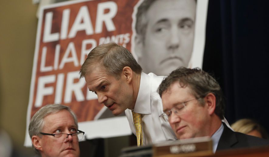 Rep. Jim Jordan, R-Ohio, center, ranking member of the Committee on Oversight and Reform talks with Rep. Mark Meadows, R-N.C., left, and Rep. Thomas Massie, R-Ky., right, during testimony by Michael Cohen, President Donald Trump&#39;s former personal lawyer on Capitol Hill in Washington, Wednesday, Feb. 27, 2019. (AP Photo/Pablo Martinez Monsivais)