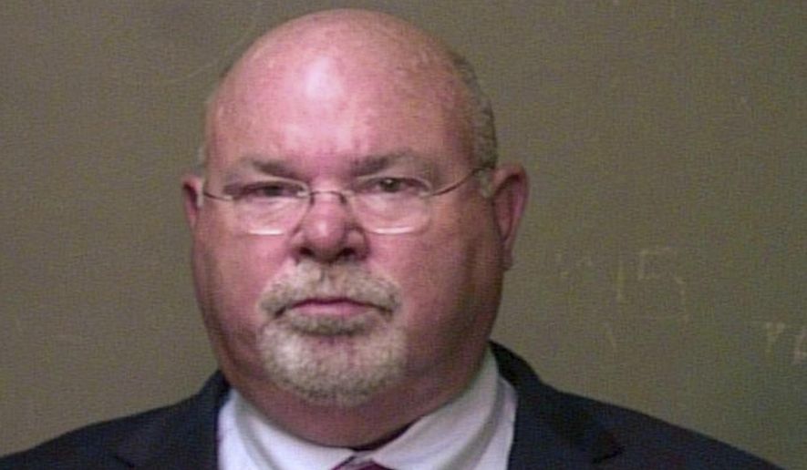 In this June 30, 2016 photo provided by the Oklahoma County Sheriff's Office, Dr. John A. Fuller is pictured in a booking photo. Rape and sexual battery charges have been dismissed against Fuller, who agreed to stop practicing medicine. Oklahoma County court records indicate the charges were dismissed Monday, Feb. 25, 2019 against 65-year-old Dr. John A. Fuller after he agreed to not practice medicine again. (Oklahoma County Sheriff's Office via AP)