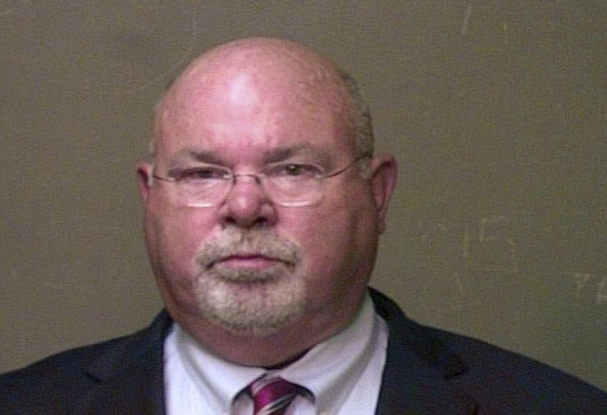 In this June 30, 2016 photo provided by the Oklahoma County Sheriff's Office, Dr. John A. Fuller is pictured in a booking photo. Rape and sexual battery charges have been dismissed against Fuller, who agreed to stop practicing medicine. Oklahoma County court records indicate the charges were dismissed Monday, Feb. 25, 2019 against 65-year-old Dr. John A. Fuller after he agreed to not practice medicine again. (Oklahoma County Sheriff's Office via AP)