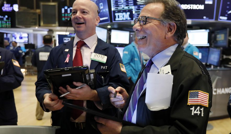 FILE- In this Feb. 15, 2019, file photo traders Patrick Casey, left, and Sal Suarino work on the floor of the New York Stock Exchange. The U.S. stock market opens at 9:30 a.m. EST on Wednesday, Feb. 27. (AP Photo/Richard Drew, File)