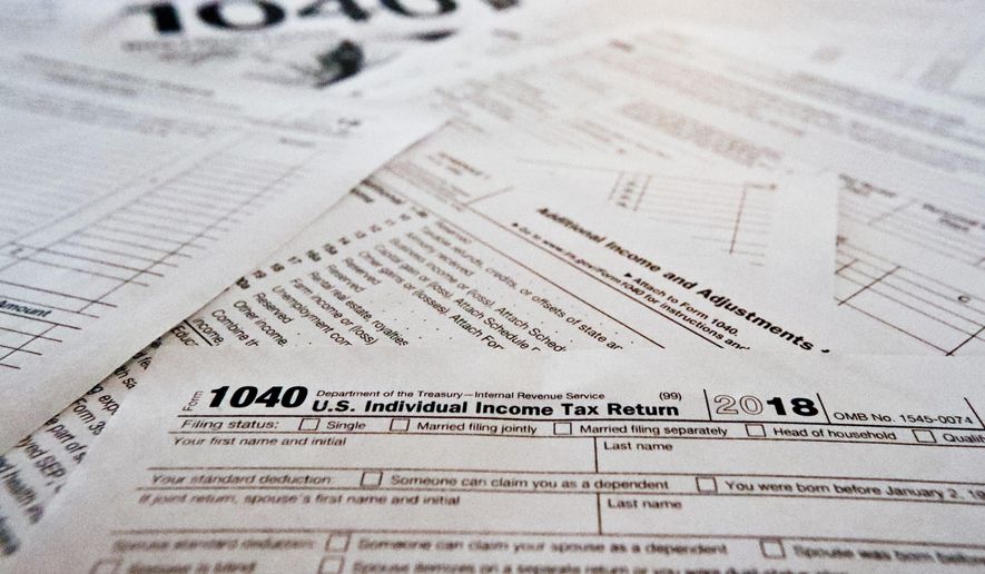This Feb. 13, 2019, file photo shows multiple forms printed from the Internal Revenue Service web page that are used for 2018 U.S. federal tax returns in Zelienople, Pa.  It’s tough to know all the answers at tax time, particularly in a year with massive tax law changes. Sometimes people need help, but where should they turn? There are several options. (Associated Press) **FILE**