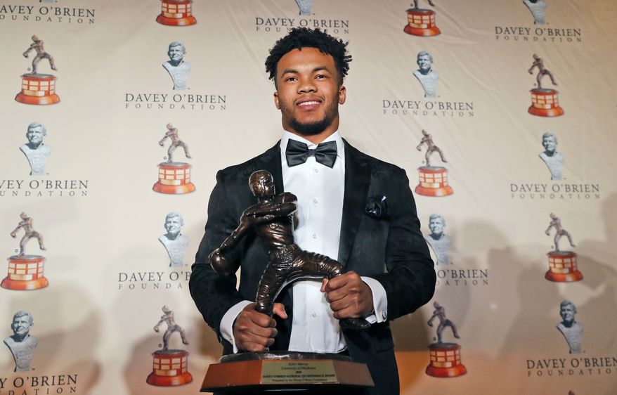 FILE - In this Feb. 18, 2019, file photo, Heisman Trophy winning quarterback Kyler Murray poses with the Davey O'Brien football award, in Fort Worth, Texas. Murray's measurements were among the most anticipated at this year's NFL scouting combine after he spurned the Oakland Athletics and a career in Major League Baseball for a shot at the NFL. (AP Photo/LM Otero) ** FILE **