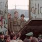 ** PACKAGE TO GO WITH THE 20TH ANNIVERSARY OF THE FALL OF THE BERLIN WALL ** SIX OF TWENTY ** FILE - East German border guards look through a hole in the Berlin wall after demonstrators pulled down one segment of the wall at Brandenburg gate in this Nov. 11, 1989 file picture. Monday, Nov. 9, 2009 marks the 20th anniversary of the fall of the Berlin Wall. (AP Photo/Lionel Cironneau)