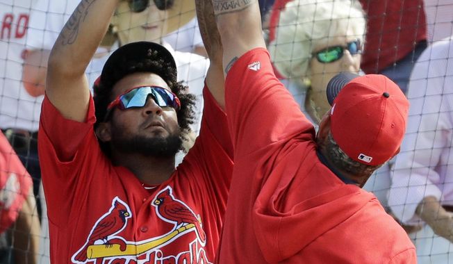 St. Louis Cardinals&#x27; Jose Martinez, left, and Yadier Molina celebrate following a three-run home run by teammate Ramon Urias during the fifth inning of an exhibition spring training baseball game against the Miami Marlins Saturday, Feb. 23, 2019, in Jupiter, Fla. (AP Photo/Jeff Roberson)