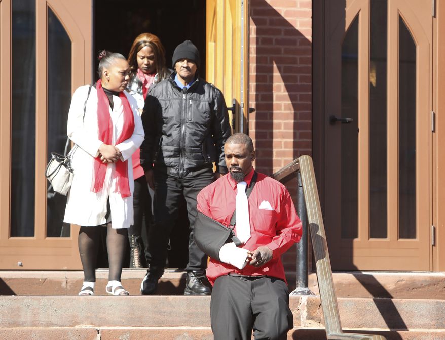 Family members follow Shawn DeLoatch, foreground right, as he steps out of St. Ann's Church in Nyack, N.Y., for a moment before his wife's funeral Thursday, Feb. 28, 2019. Melissa DeLoatch, a pregnant mother of six, was killed when her family was run over outside a Haverstraw, N.Y. convenience store on Feb. 20, 2019. Police allege that a driver intentionally plowed into the family after words were exchanged about his smoking. (Tania Savayan/The Journal News via AP)