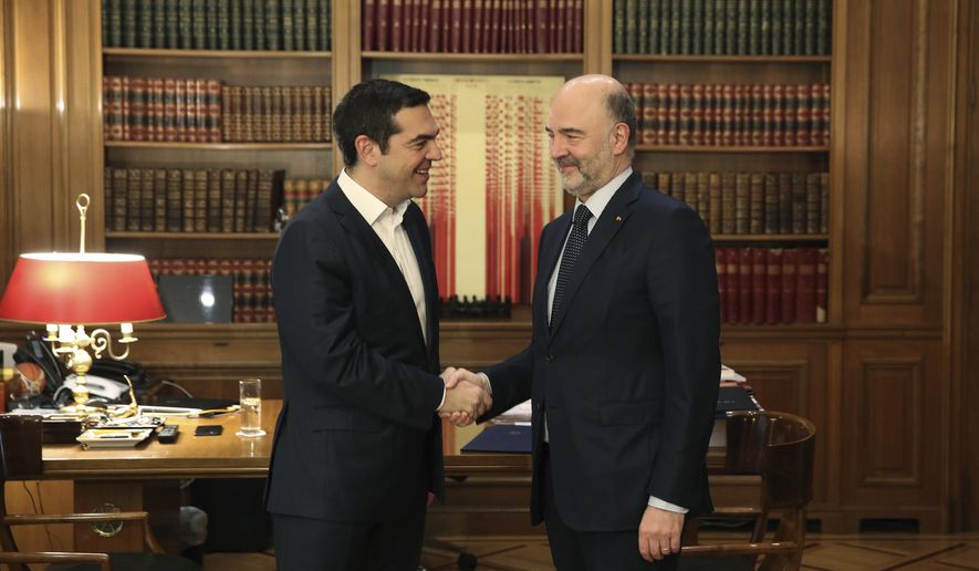 Greek Prime Minister Alexis Tsipras, left, meets with European Commissioner for Economic and Financial Affairs Pierre Moscovici in Athens, on Thursday, Feb. 28, 2019. (AP Photo/Petros Giannakouris)