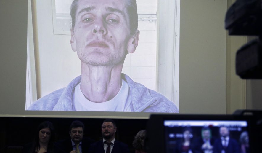 A photograph of the Russian cybercrime suspect Russian man Alexander Vinnik is on display on a screen during a press conference by his lawyers in Athens, Thursday, Feb. 28, 2019.   Zoe Konstantopoulou, the lawyer for Vinnik, suspected of bitcoin fraud and wanted by three countries says his health is deteriorating due to a hunger strike and criticized the Greek courts for holding him in custody for more than the maximum 18 months allowed. (AP Photo/Thanassis Stavrakis)