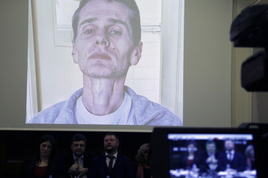A photograph of the Russian cybercrime suspect Russian man Alexander Vinnik is on display on a screen during a press conference by his lawyers in Athens, Thursday, Feb. 28, 2019.   Zoe Konstantopoulou, the lawyer for Vinnik, suspected of bitcoin fraud and wanted by three countries says his health is deteriorating due to a hunger strike and criticized the Greek courts for holding him in custody for more than the maximum 18 months allowed. (AP Photo/Thanassis Stavrakis)