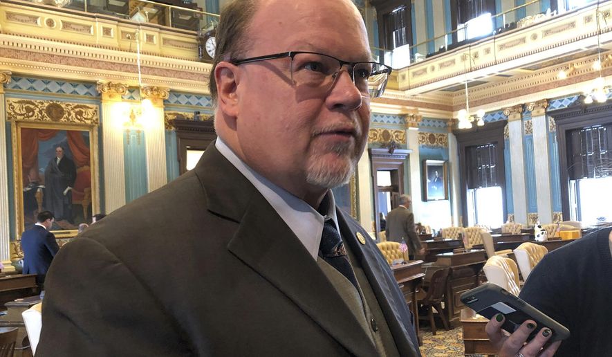 State Sen. Jim Runestad, R-White Lake Township, speaks with reporters after the passage of his bill to combat mail theft on Thursday, Feb. 28, 2019, at the Capitol in Lansing, Mich. The Senate voted unanimously Thursday to send two bills to the House that would make the theft of mail and packages a state crime. Law enforcement says U.S. postal inspectors are currently overwhelmed with investigating what is a federal crime. (AP Photo/David Eggert)