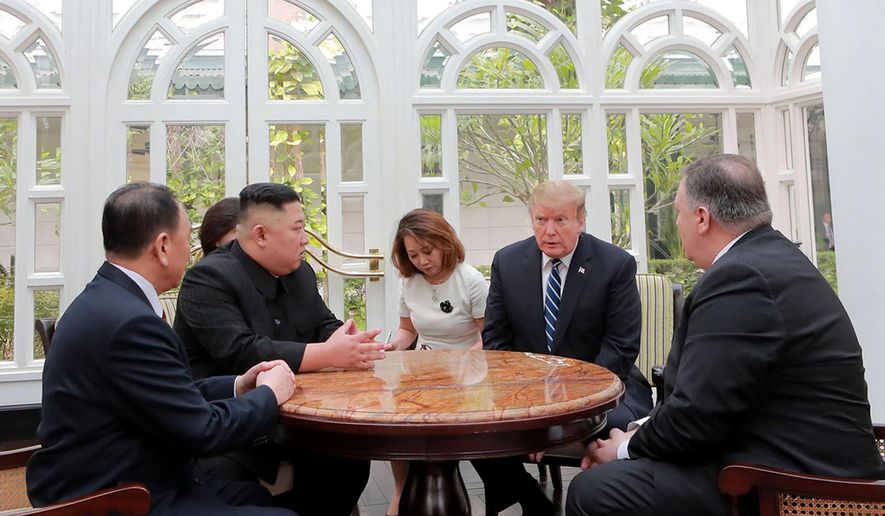 ALTERNATE CROP OF KNS802 - In this Thursday, Feb. 28, 2019, photo provided Friday, March 1, 2019, by the North Korean government, U.S. President Donald Trump, second from right, and North Korean leader Kim Jong Un, second from left, talk at a hotel in Hanoi, Vietnam. U.S. Sec. of State Mike Pompeo is at right. Kim Yong Chol, a North Korean senior ruling party official and former intelligence chief is at left. The content of this image is as provided and cannot be independently verified. (Korean Central News Agency/Korea News Service via AP)