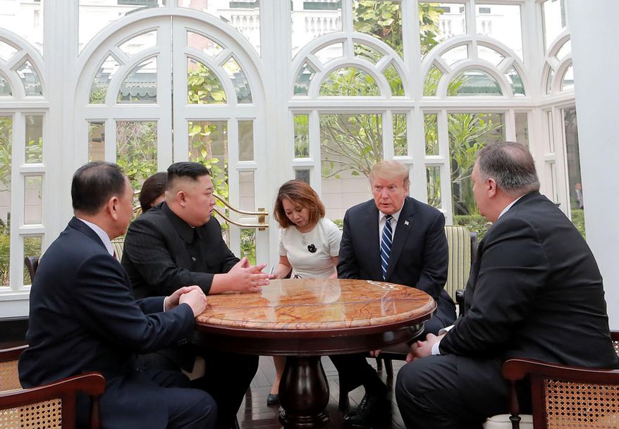 ALTERNATE CROP OF KNS802 - In this Thursday, Feb. 28, 2019, photo provided Friday, March 1, 2019, by the North Korean government, U.S. President Donald Trump, second from right, and North Korean leader Kim Jong Un, second from left, talk at a hotel in Hanoi, Vietnam. U.S. Sec. of State Mike Pompeo is at right. Kim Yong Chol, a North Korean senior ruling party official and former intelligence chief is at left. The content of this image is as provided and cannot be independently verified. (Korean Central News Agency/Korea News Service via AP)