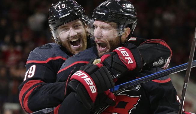 Carolina Hurricanes&#x27; Dougie Hamilton (19) celebrates with Jordan Staal (11) following Staal&#x27;s goal against the St. Louis Blues&#x27; during the third period of an NHL hockey game in Raleigh, N.C., Friday, March 1, 2019. Carolina won 5-2. (AP Photo/Gerry Broome)