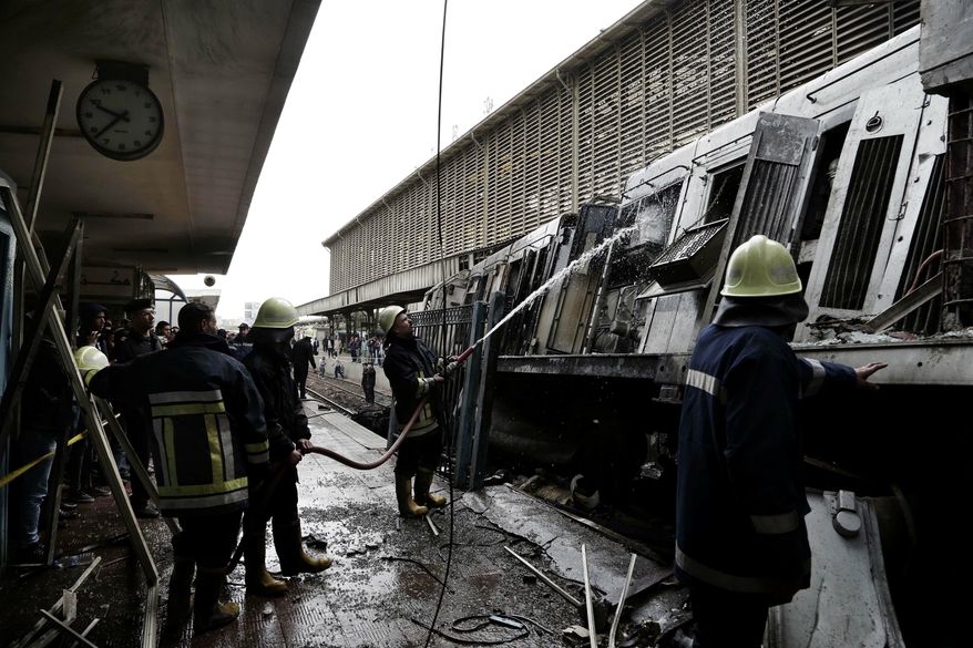 Firefighters hose down a train that was damaged after a crash inside Ramsis train station in Cairo, Egypt, Wednesday, Feb. 27, 2019. An Egyptian medical official said at least 20 people have been killed and dozens injured after a railcar rammed into a barrier inside the station causing an explosion of the fuel tank and triggering a huge blaze that engulfed that part of the station. The head of the Cairo Railroad Hospital said the death toll is expected to rise further. (AP Photo/Nariman El-Mofty) ** FILE **