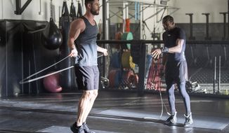 In this undated image provided courtesy of Centr, actor Chris Hemsworth, left, and Michael Olajide Jr. workout. When Hemsworth sought &amp;quot;experts&amp;quot; to contribute to a fitness and health app called Centr, one place he turned was to the boxing ring. He found Olajide Jr., a former middleweight contender who literally lost an eye to his sport. (Courtesy of Centr via AP)