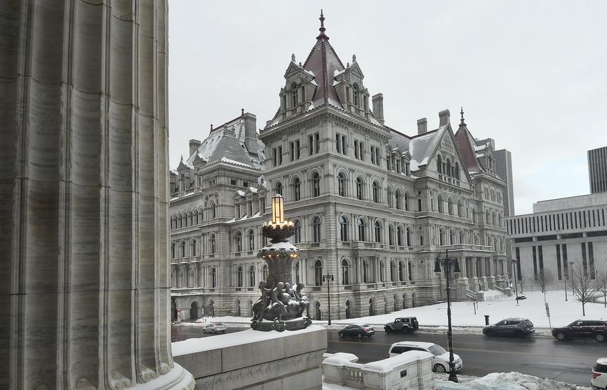 FILE - This Feb. 13, 2019 file photo shows the New York state Capitol building as seen from the steps of the New York state Education Department Building, in Albany, N.Y. Though leaders such as Democratic Gov. Andrew Cuomo insist New York has a tough law on sexual harassment, with more changes proposed in the current legislative session, allegations that roiled a 20-employee office in Glens Falls underscore a familiar criticism: Aggressive policies at state agencies aren't of much use if managers don't take action. (AP Photo/Hans Pennink, File)