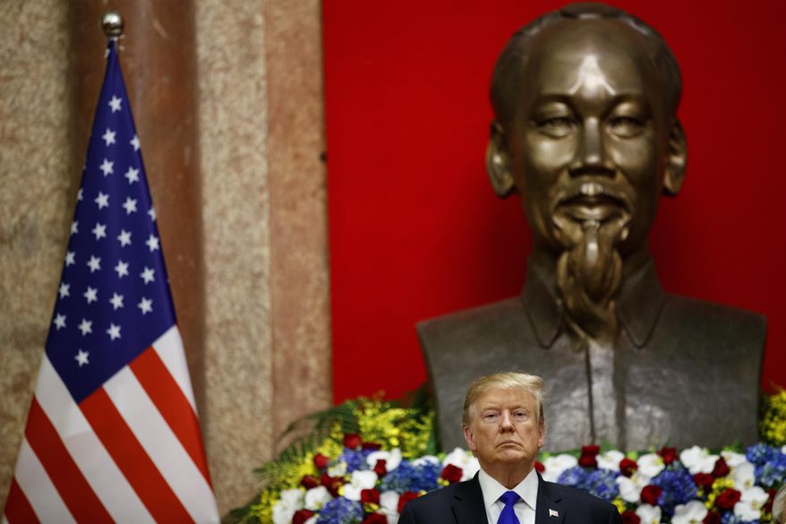 In this Feb. 27, 2019, photo, President Donald Trump listens during a signing ceremony for commercial trade agreements with Vietnamese President Nguyen Phu Trong at the Presidential Palace, in Hanoi. (AP Photo/ Evan Vucci, File)