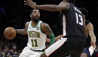 Boston Celtics guard Kyrie Irving (11) makes a move against Washington Wizards center Thomas Bryant (13) during the first quarter of an NBA basketball game Friday, March 1, 2019, in Boston. (AP Photo/Elise Amendola)