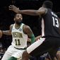 Boston Celtics guard Kyrie Irving (11) makes a move against Washington Wizards center Thomas Bryant (13) during the first quarter of an NBA basketball game Friday, March 1, 2019, in Boston. (AP Photo/Elise Amendola)