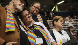 FILE - In this Feb. 26, 2019, file photo, Ed Rowe, left, Rebecca Wilson, Robin Hager and Jill Zundel, react to the defeat of a proposal that would allow LGBT clergy and same-sex marriage within the United Methodist Church at the denomination&#39;s 2019 Special Session of the General Conference in St. Louis, Mo. The church ended a pivotal conference on Feb. 26 in a seemingly irreconcilable split over same-sex marriage and the ordination of LGBT clergy. (AP Photo/Sid Hastings, File)