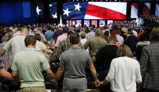 In this June 12, 2018, file photo, people pray for America at the 2018 Annual Meeting of the Southern Baptist Convention at the Kay Bailey Hutchison Dallas Convention Center in Dallas. The SBC confronted a sex-abuse crisis in the form of an investigation by the Houston Chronicle and San Antonio Express-News. The newspapers reported that hundreds of Southern Baptist clergy and staff had been accused of sexual misconduct over the past 20 years. (Vernon Bryant/The Dallas Morning News via AP, File)