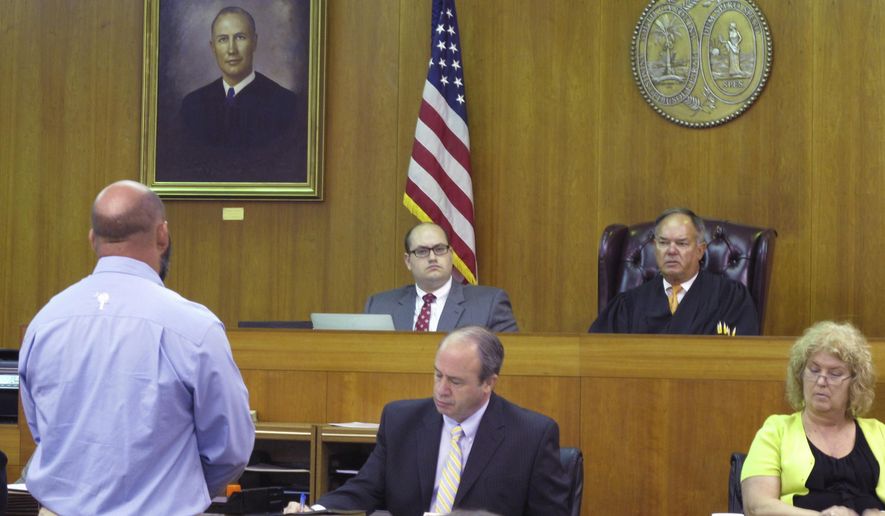 FILE - In this Aug. 6, 2012, file photo, former Saluda County Sheriff Jason Booth, left, tells the people of his county he is sorry as Judge Doyet "Jack" Early III, seated at upper right, listens during Booth's guilty plea to a misconduct in office charge at the Aiken County Courthouse in Aiken, S.C. A bill in the South Carolina General Assembly would prevent any law officer convicted of a felony or a crime involving using a public office for a personal gain from being eligible to run for sheriff of a county. (AP Photo/Jeffrey Collins, File)