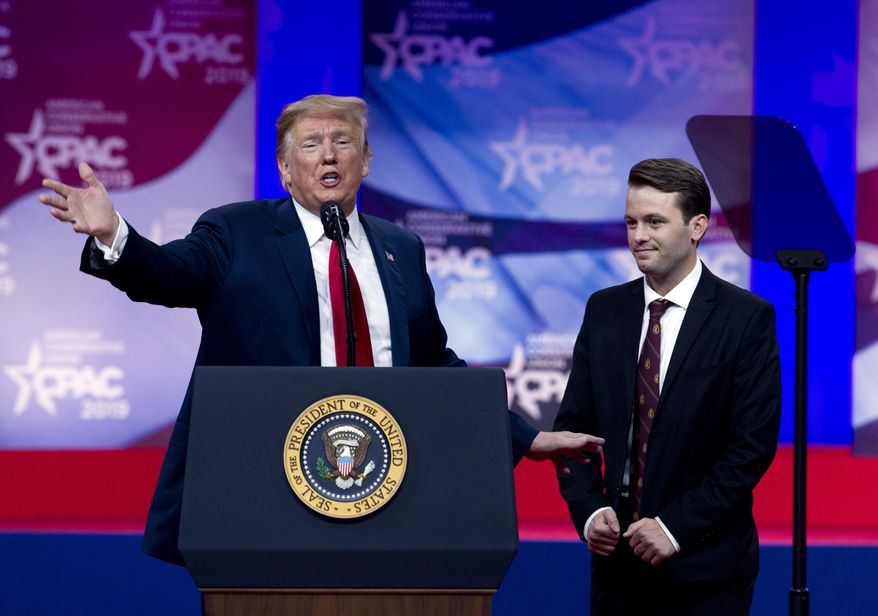 President Donald Trump invites to speak in the podium to Hayden Williams, a field representative of the Leadership Institute, who was assaulted at Berkeley campus speaks at Conservative Political Action Conference, CPAC 2019, in Oxon Hill, Md., Saturday, March 2, 2019. (AP Photo/Jose Luis Magana)