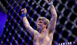 Ben Askren celebrates after defeating Robbie Lawler in a welterweight mixed martial arts bout at UFC 235, Saturday, March 2, 2019, in Las Vegas. (AP Photo/John Locher)