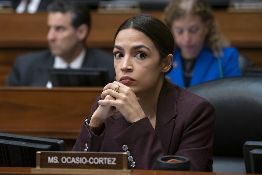 Rep. Alexandria Ocasio-Cortez, D-N.Y., listens to questioning of Michael Cohen, President Donald Trump's former personal lawyer, at the House Oversight and Reform Committee, on Capitol Hill in Washington, Wednesday, Feb. 27, 2019. (AP Photo/J. Scott Applewhite)