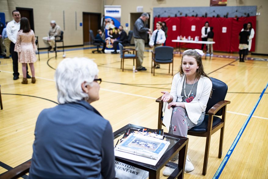 Halee Butler, right, talks to Martha Madison of Bowling Green during The Amazing Shake on Tuesday, Feb. 26, 2019, at Bristow Elementary School in Bowling Green, Ky. (Austin Anthony/Daily News via AP)