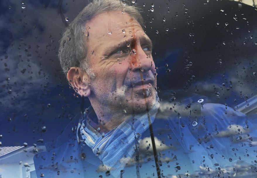 In this photo taken on Monday, Oct. 10, 2016, Greek photojournalist Yannis Behrakis looks on during a visit at Normandy, France. Yannis Behrakis, a Pulitzer Prize-winning photojournalist, has died. He was 58. His death Saturday, March 2, 2019 was confirmed by his employers, Reuters, where he had worked since 1987. Behrakis had long been ill with cancer. (AP Photo/Enric Marti)