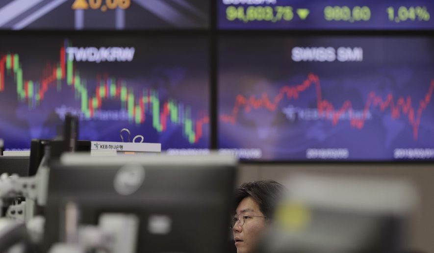 A currency trader watches computer monitors at the foreign exchange dealing room in Seoul, South Korea, Monday, March 4, 2019. Asian stocks rose Monday after news reports said Washington and Beijing are close to reaching an agreement as early as this month to end their costly tariff war. (AP Photo/Lee Jin-man)