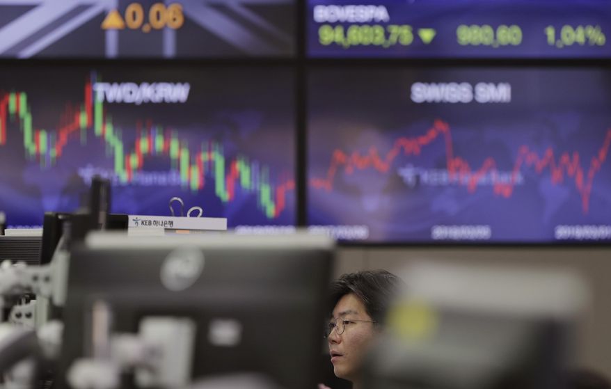 A currency trader watches computer monitors at the foreign exchange dealing room in Seoul, South Korea, Monday, March 4, 2019. Asian stocks rose Monday after news reports said Washington and Beijing are close to reaching an agreement as early as this month to end their costly tariff war. (AP Photo/Lee Jin-man)