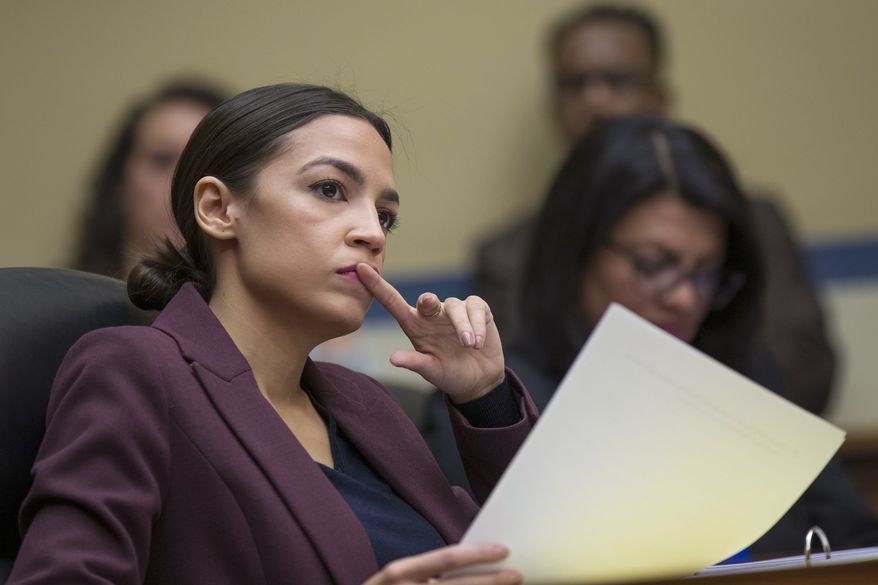 Rep. Alexandria Ocasio-Cortez, D-N.Y., listens to questions as Michael Cohen, President Donald Trump's former personal lawyer, testifies before the House Oversight and Reform Committee on Capitol Hill in Washington on Feb. 27, 2019. (AP Photo/Alex Brandon) ** FILE **