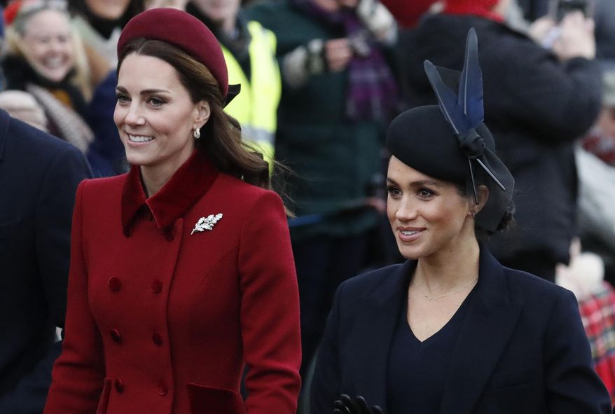FILE - In this Tuesday, Dec. 25, 2018 file photo, Britain's Kate, Duchess of Cambridge, left, and Meghan, Duchess of Sussex arrive to attend the Christmas day service at St Mary Magdalene Church in Sandringham in Norfolk, England. Britain’s royal family is warning that it will block trolls posting offensive messages on its social media channels _ and may report offenders to the police. Buckingham Palace, Clarence House and Kensington Palace issued new guidelines on Monday, March 4, 2019 spelling out the policy banning offensive, hateful and racist language.(AP Photo/Frank Augstein, File)