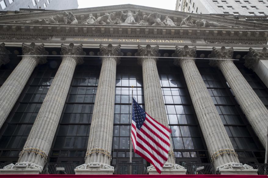 FILE- In this Nov. 20, 2018, file photo an American flag flies outside New York Stock Exchange. Stocks are opening broadly higher on Wall Street following reports that the U.S. and China are getting closer to a deal on trade. Technology stocks, industrial and internet companies were among the biggest gainers in early trading Monday, March 4, 2019. (AP Photo/Mary Altaffer, File)