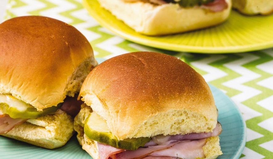 This undated photo provided by America's Test Kitchen in March 2019 shows ham and cheese sliders displayed in Boston. The recipe appears in the cookbook "The Complete Cookbook for Young Chefs." (Steve Klise/America's Test Kitchen via AP)