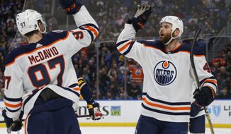 Edmonton Oilers forwards Connor McDavid (97) and Zack Kassian (44) celebrate a goal during the second period of an NHL hockey game against the Buffalo Sabres, Monday, March 4, 2019, in Buffalo N.Y. (AP Photo/Jeffrey T. Barnes)