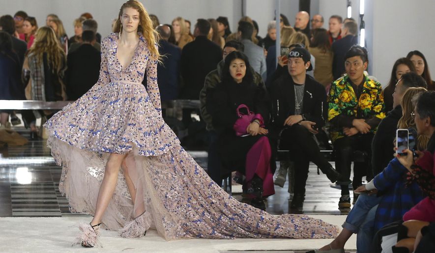 A model wears a creation as part of the Giambattista Valli ready-to-wear Fall-Winter 2019-2020 fashion collection, that was presented in Paris, Monday, March 4, 2019. (AP Photo/Michel Euler)