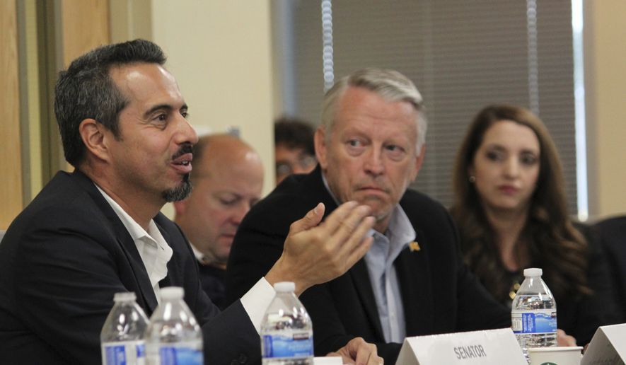 Rep. Antonio "Moe" Maestas, left, co-chair of the legislative criminal justice reform subcommittee, talks about the challenges of dealing with low-risk offenders during a meeting in Albuquerque, N.M., Wednesday, Sept. 27, 2017. The panel heard from Bernalillo County District Attorney Raul Torrez about rising crime rates in New Mexico's most populous area and the challenges his office has in managing its caseload. (AP Photo/Susan Montoya Bryan)
